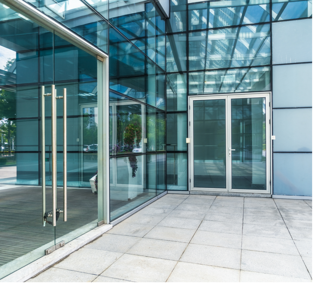 Picture of a building's finished lobby, featuring large windows and glass doors.